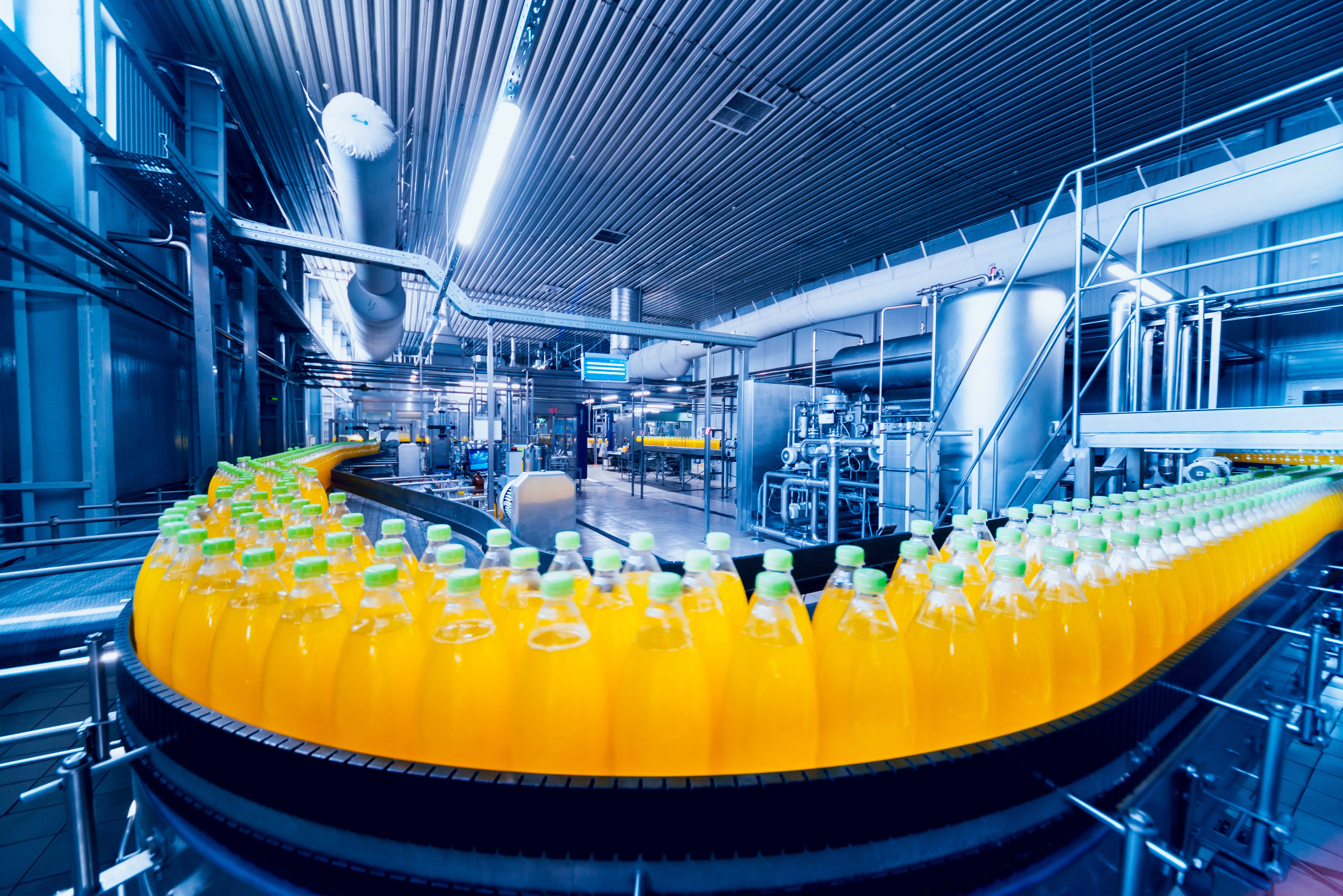 Beverage factory interior. Conveyor with bottles for juice or water. Modern equipments