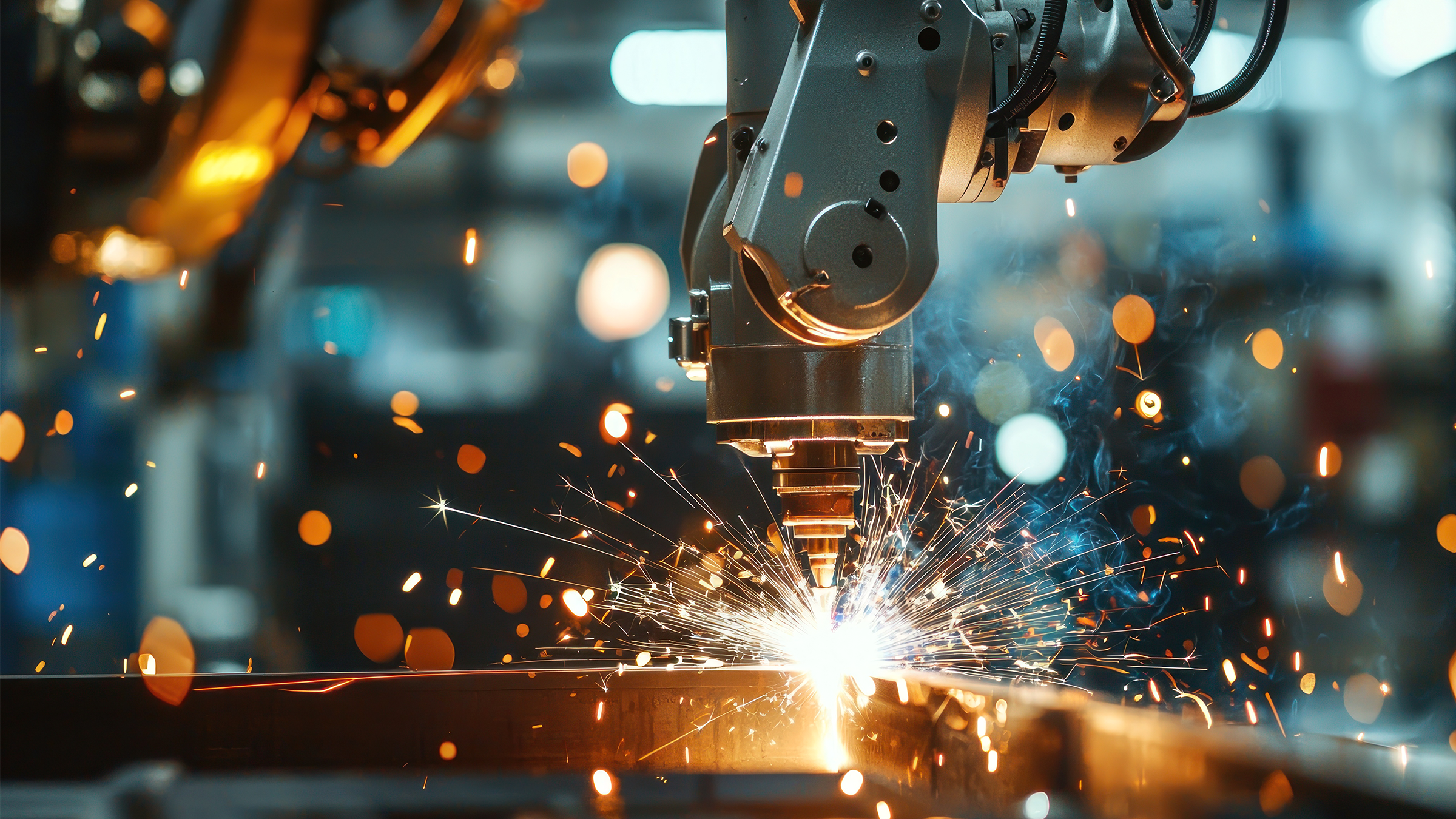 Industrial robotic arm performing an automated welding process.