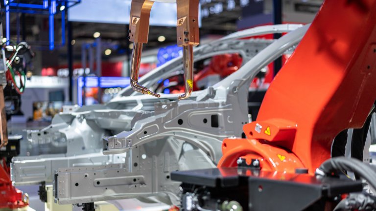 robot arm working on production floor of automotive factory