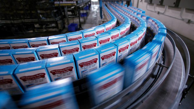 Boxes of cake mix on packing line in factory (blurred motion) 