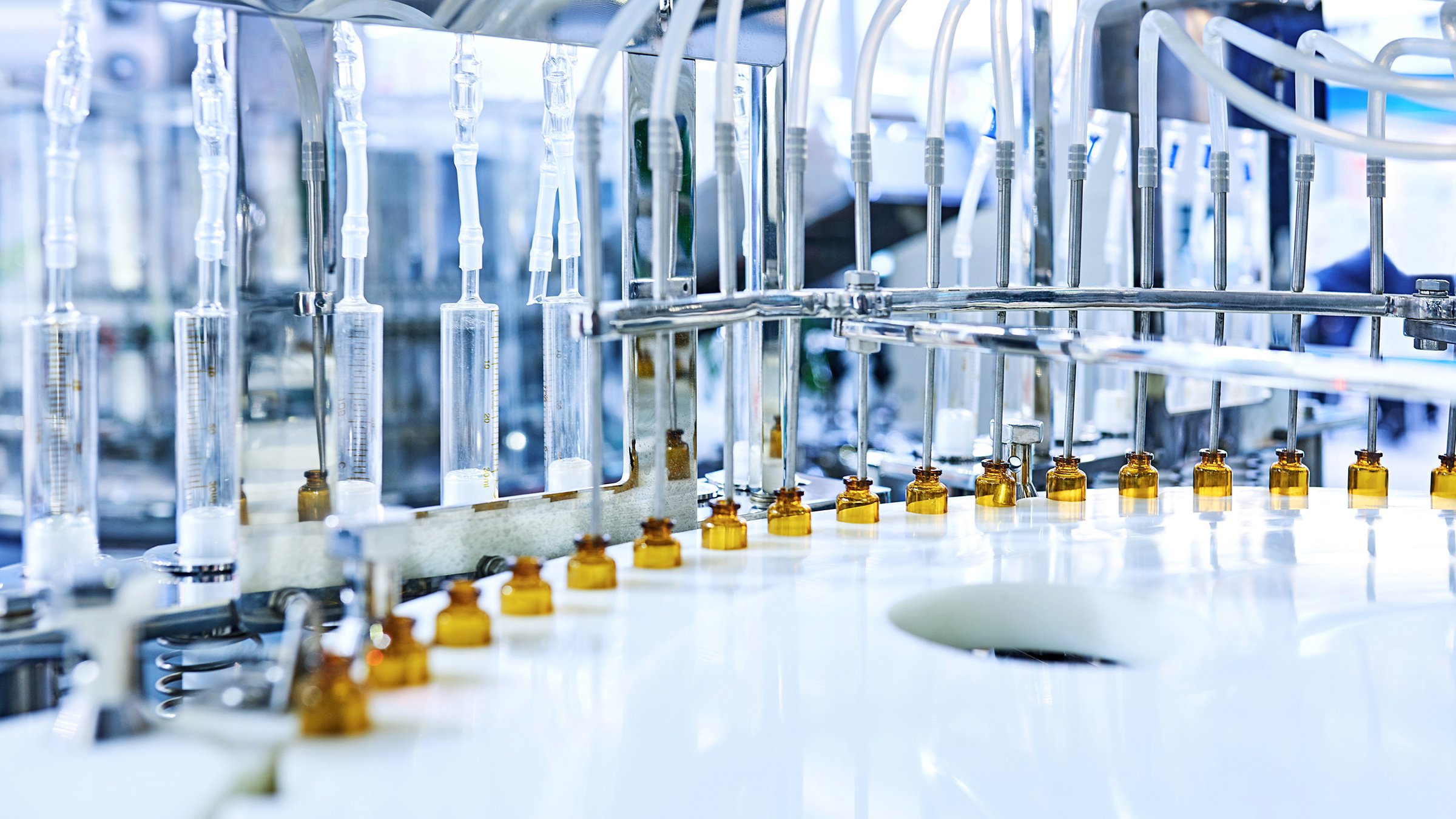 Brown medicine glass bottles on production line.