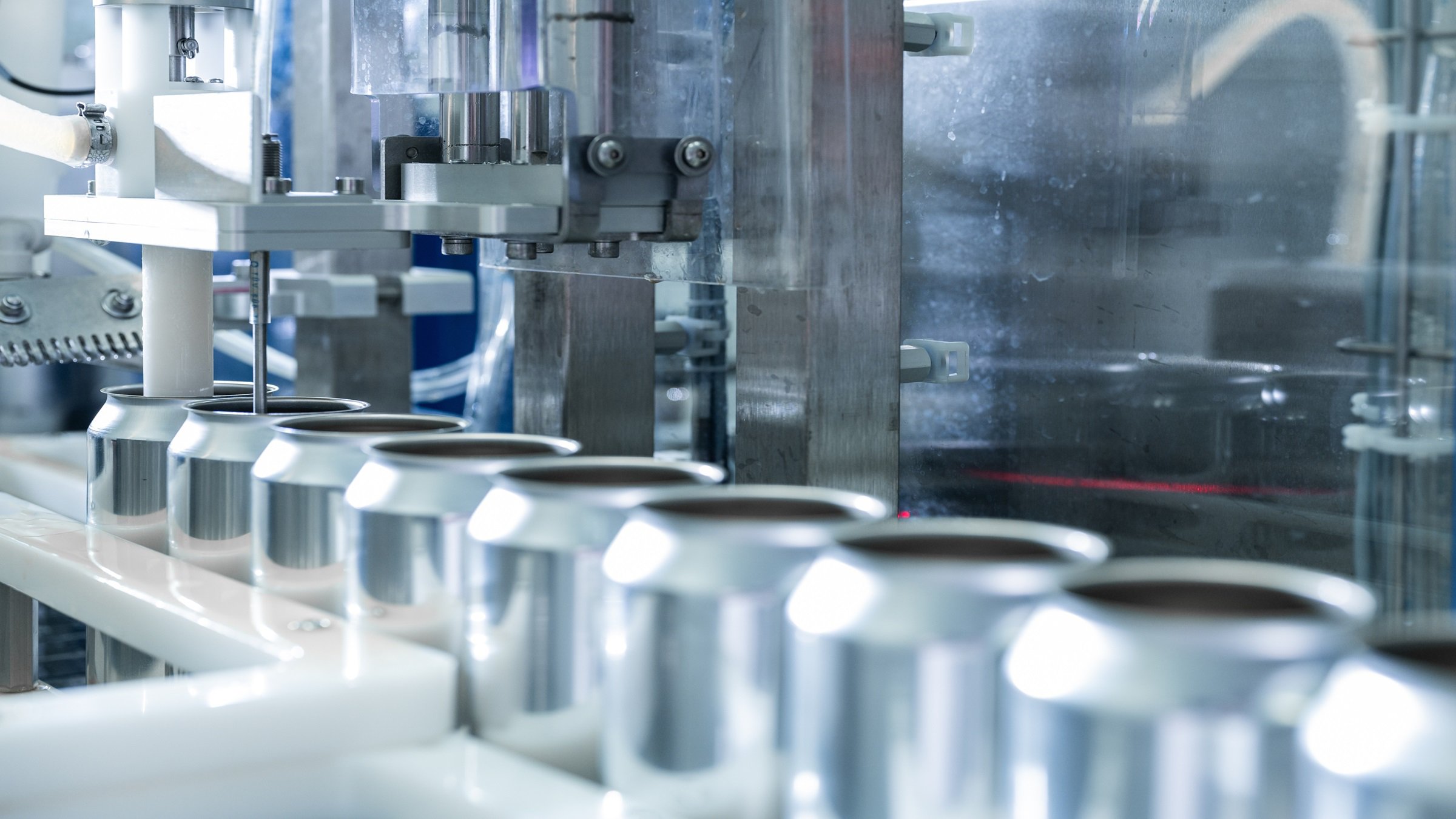 Empty new aluminum cans for drink process in factory line on conveyor belt machine at beverage manufacturing. food and beverage industrial business concept. High quality photo