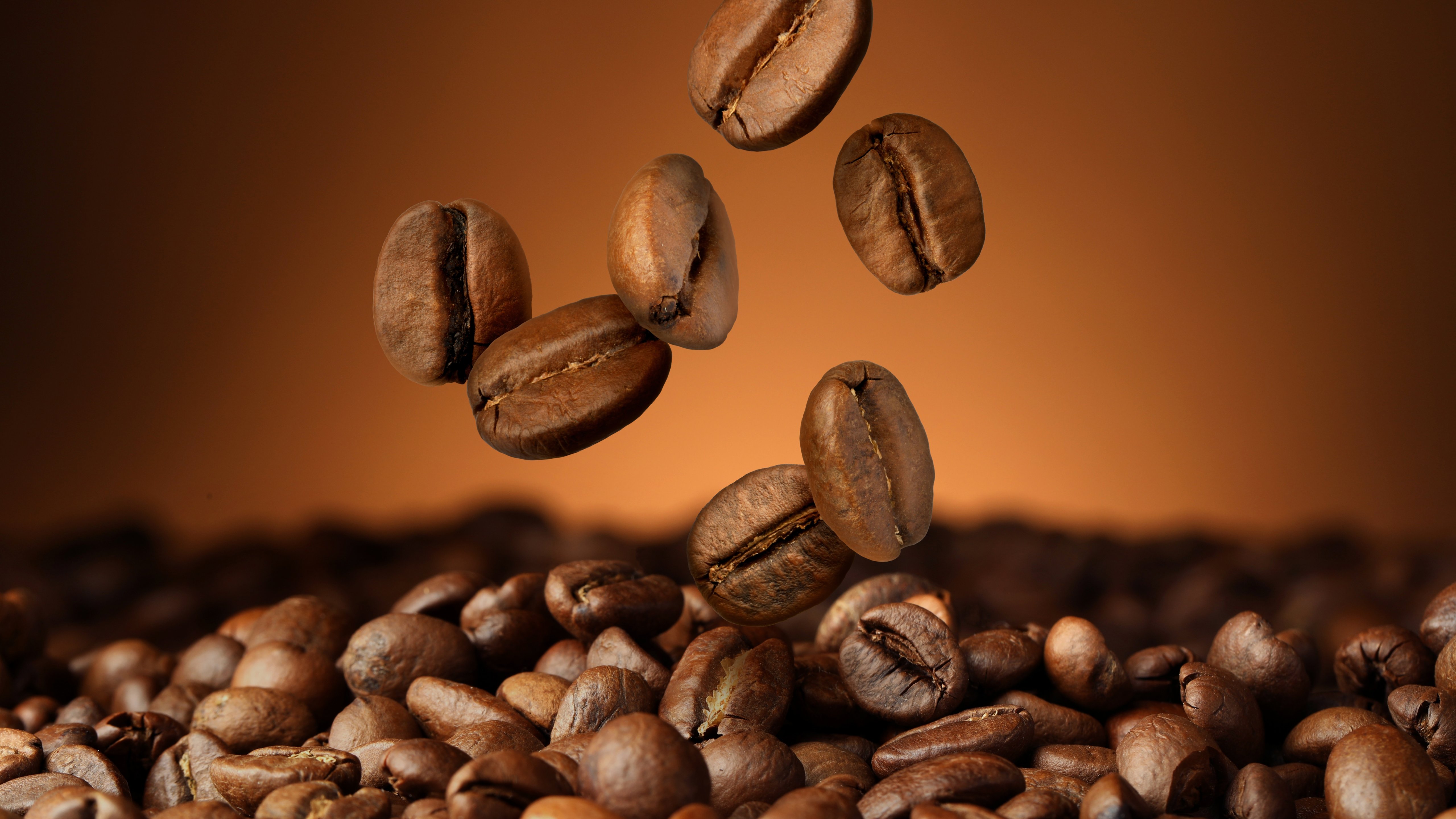 Coffee beans against brown background