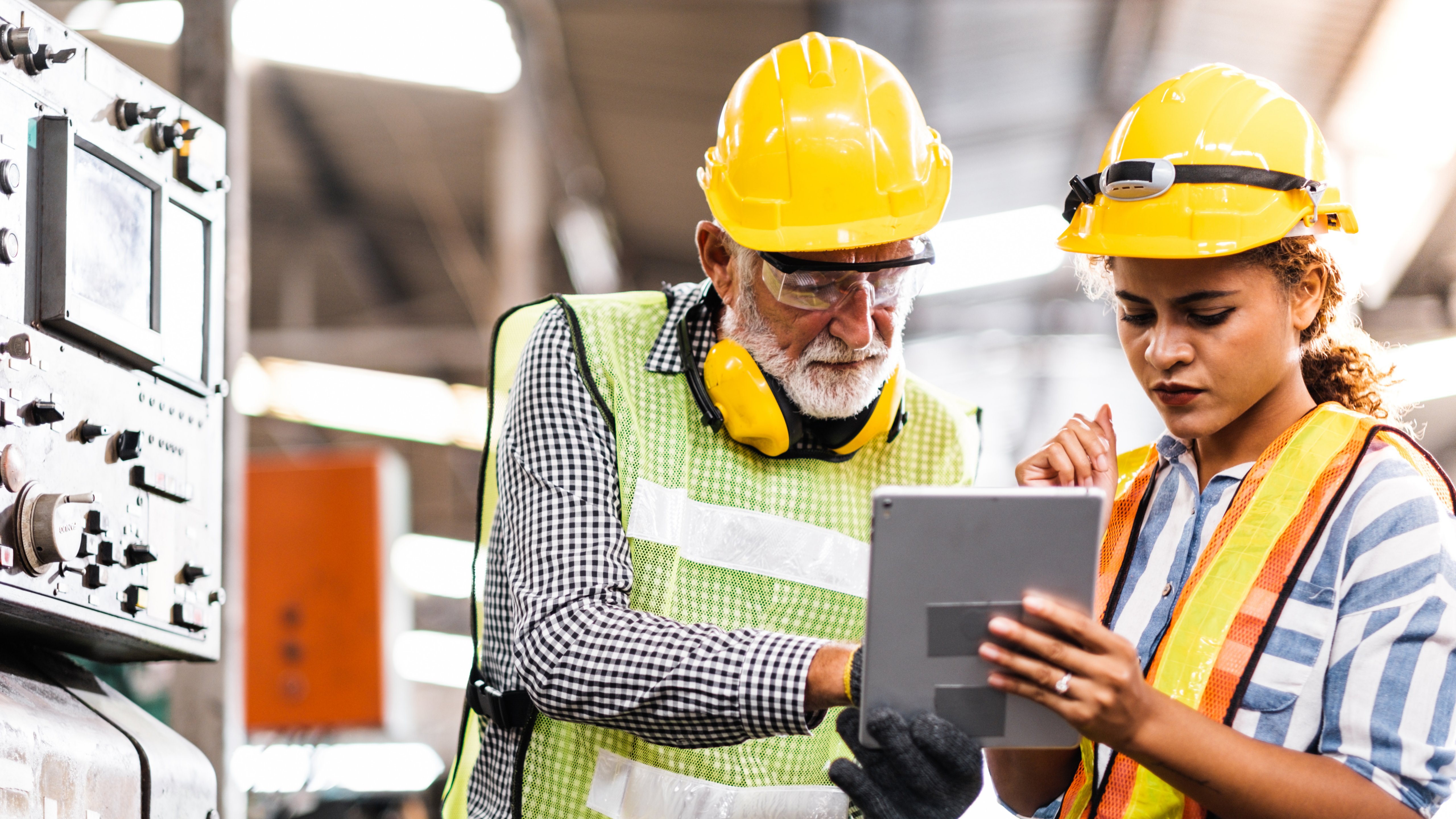 Industrial Engineers in Hard Hats.Work at the Heavy Industry Manufacturing Factory.industrial worker indoors in factory.aged man working in an industrial factory.