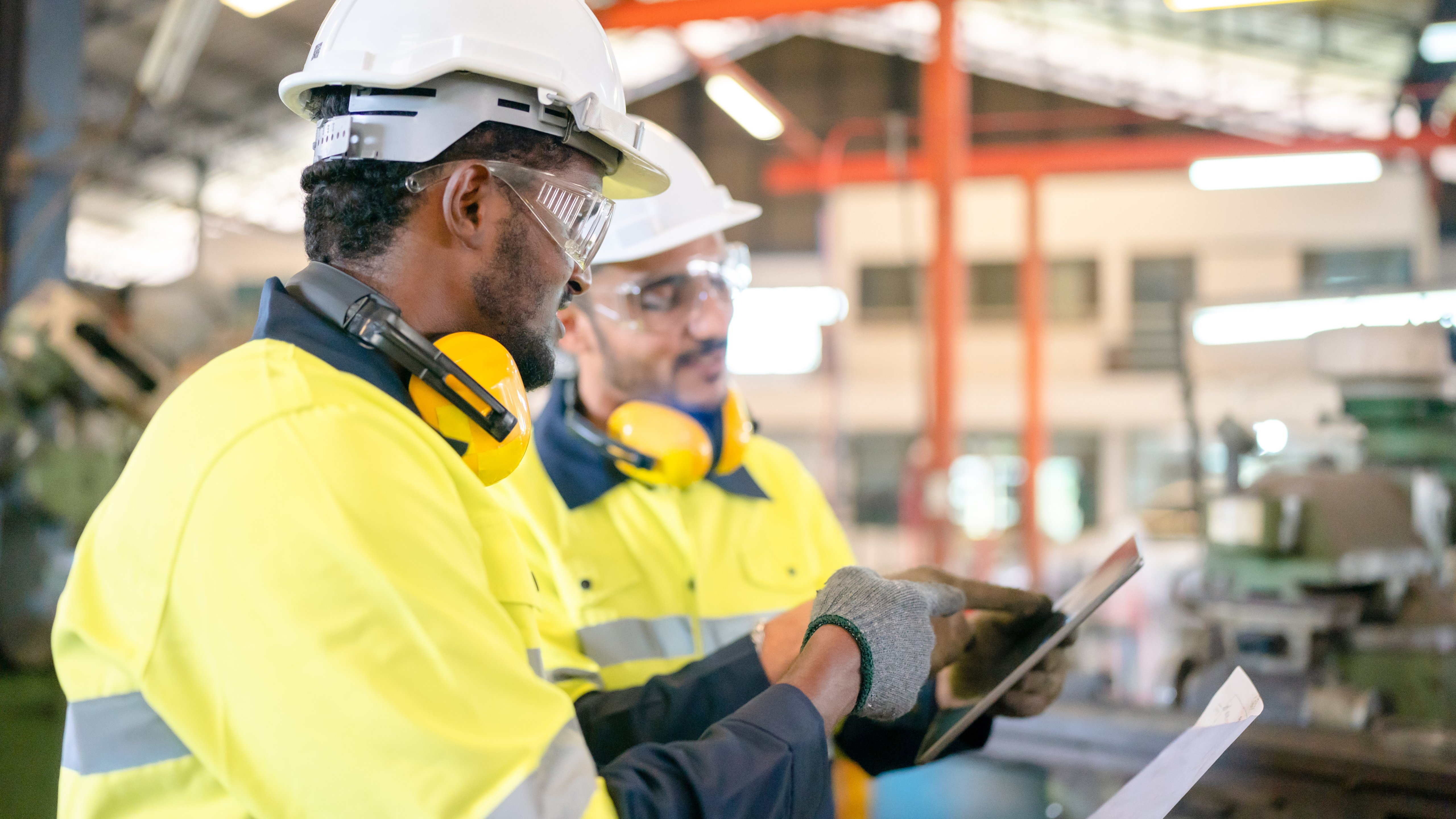 professional technician engineer with safety helmet hard hat working in industrial manufacturing factory, men at work to checking equipment of machinery production technology or construction operating