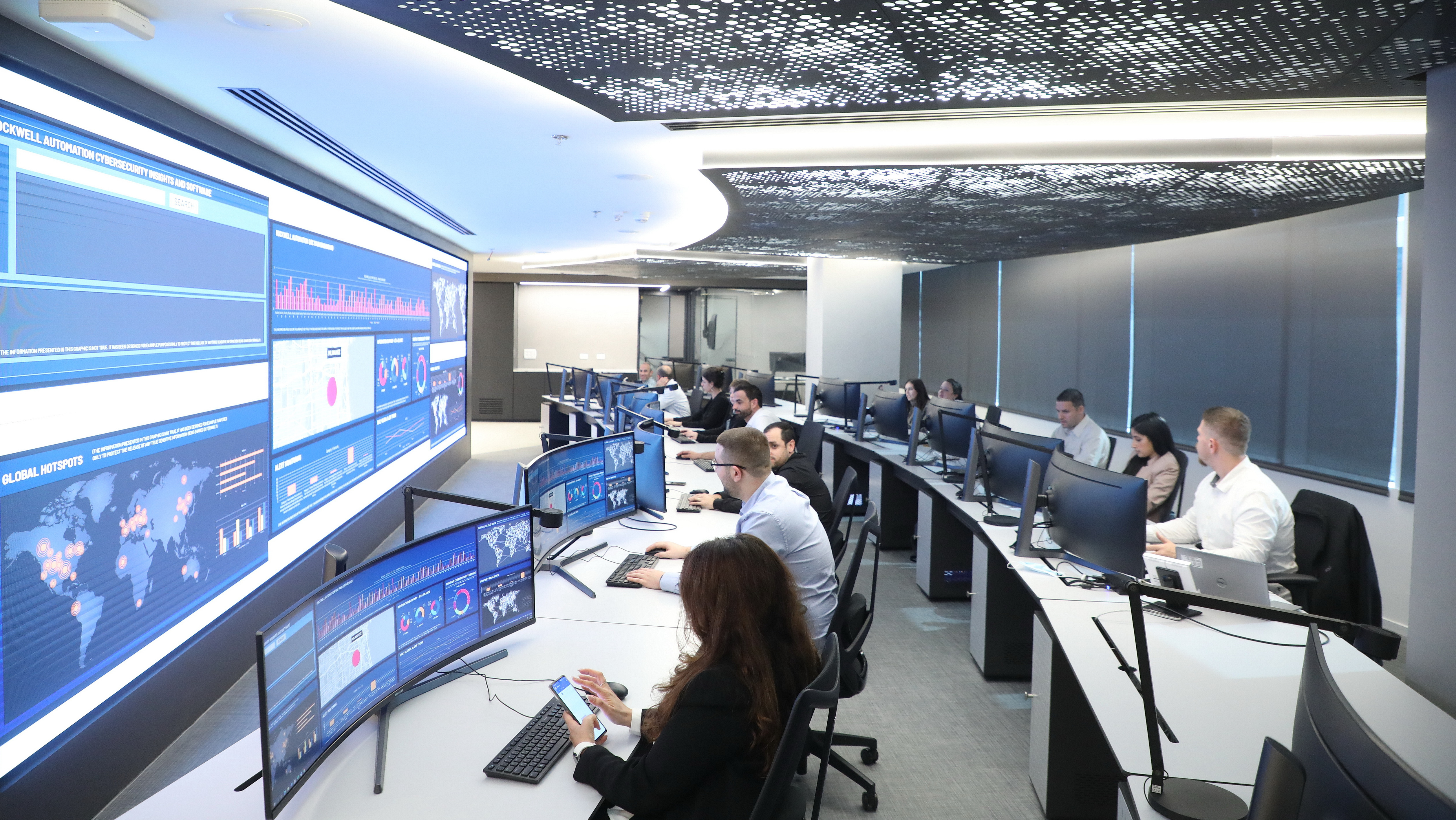 People in control room with monitors