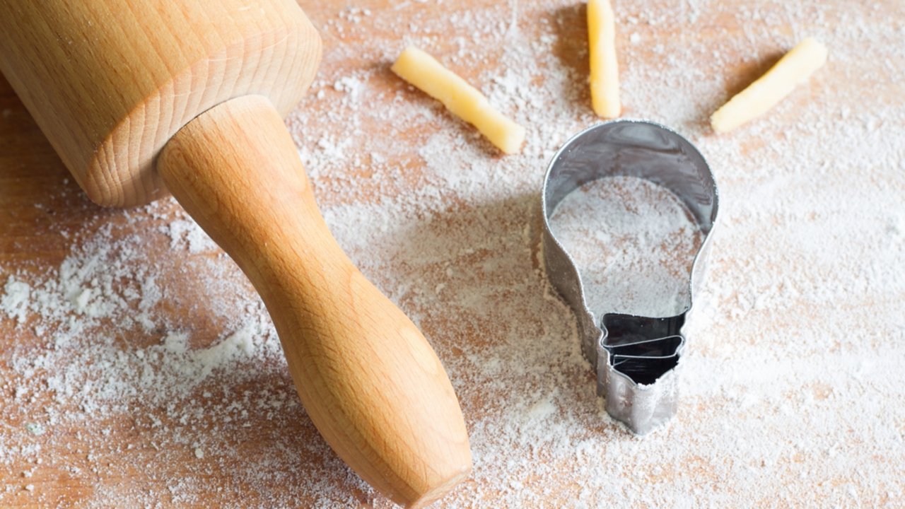 Light bulb cookie shape dough and rolling pin with flour