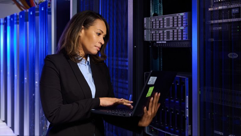 Women on laptop in data center
