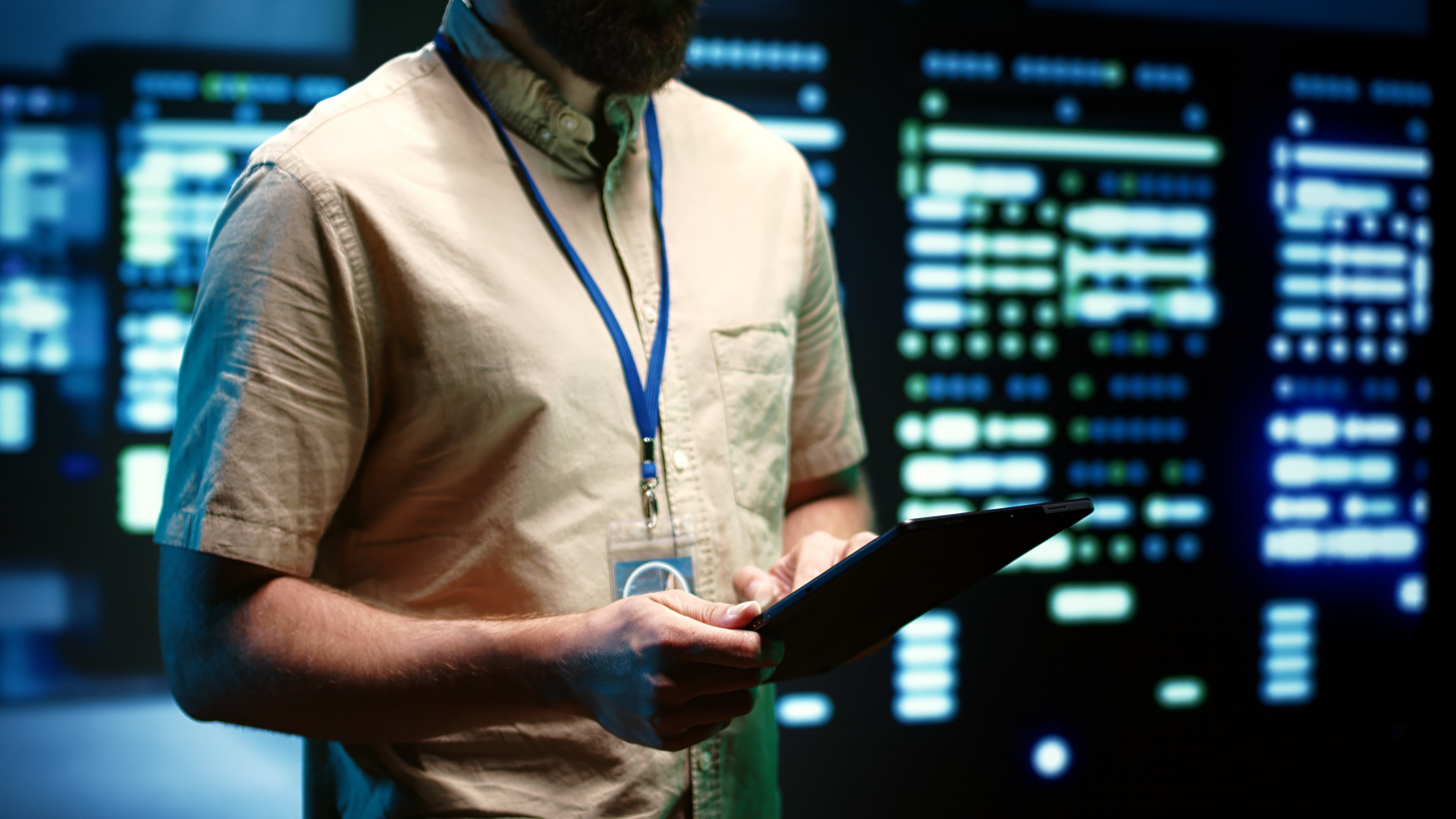 Experienced engineer inspecting operational server racks in computer network security data center. Supercomputers providing processing and memory resources for different workloads