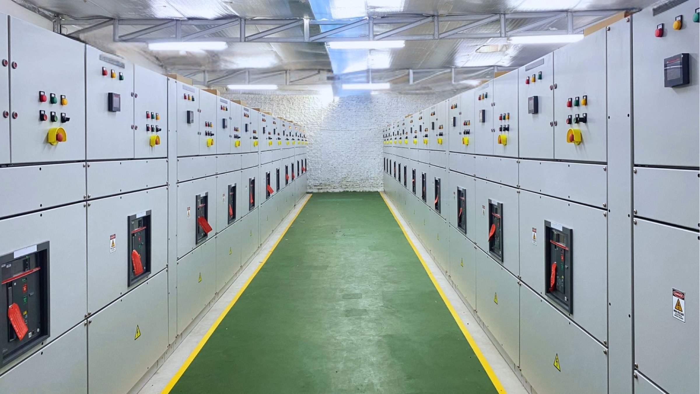 Electrical switchgear cabinets aligned in a data center facility for reliable power distribution and control.