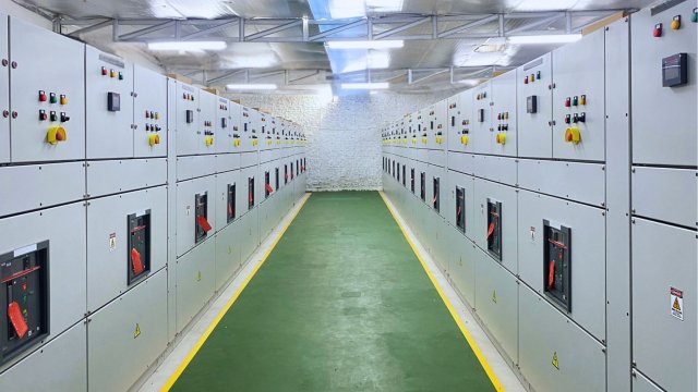 Electrical switchgear cabinets aligned in a data center facility for reliable power distribution and control.