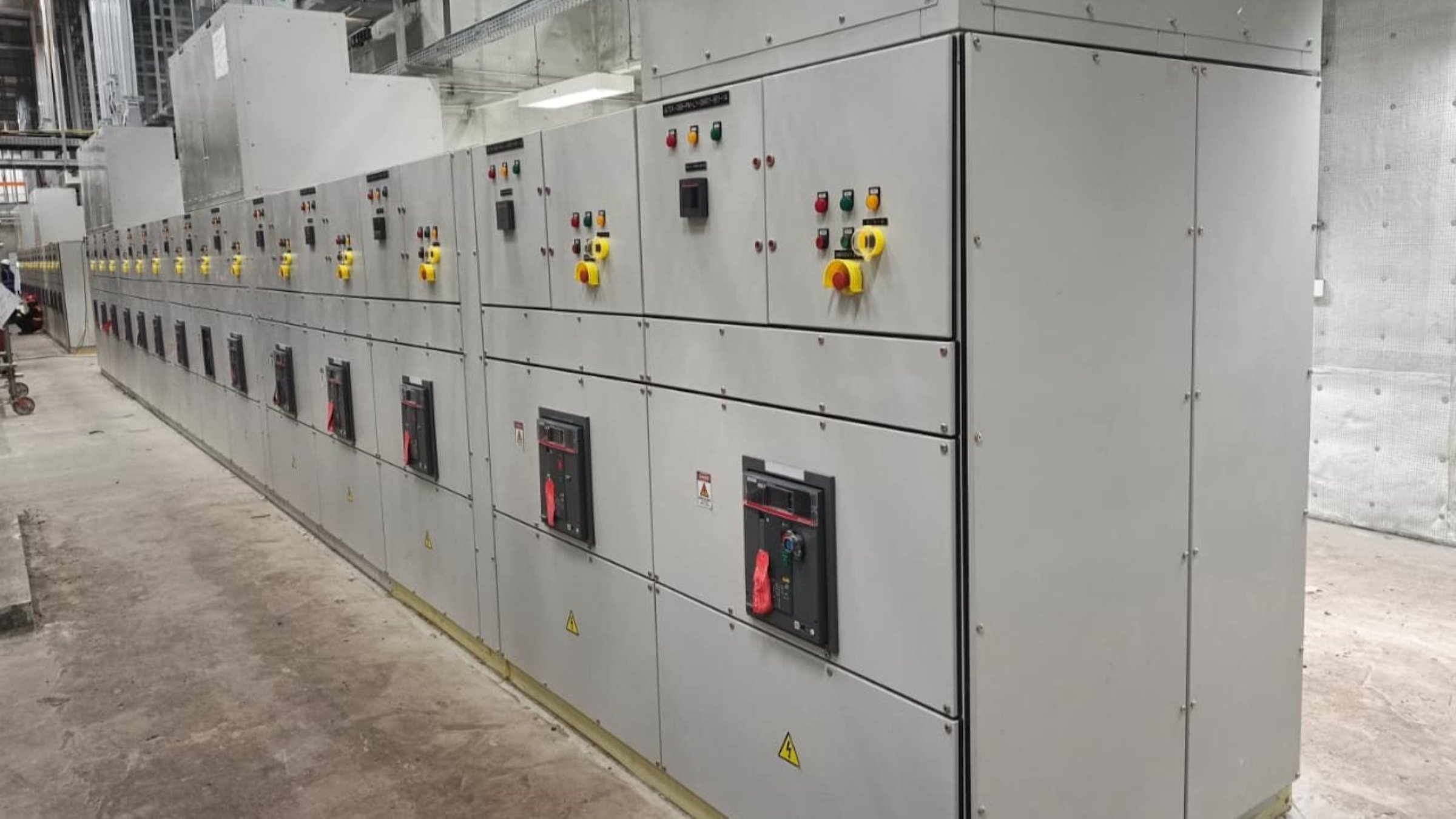 Industrial power distribution panels with circuit breakers and emergency stop controls in a data center facility.