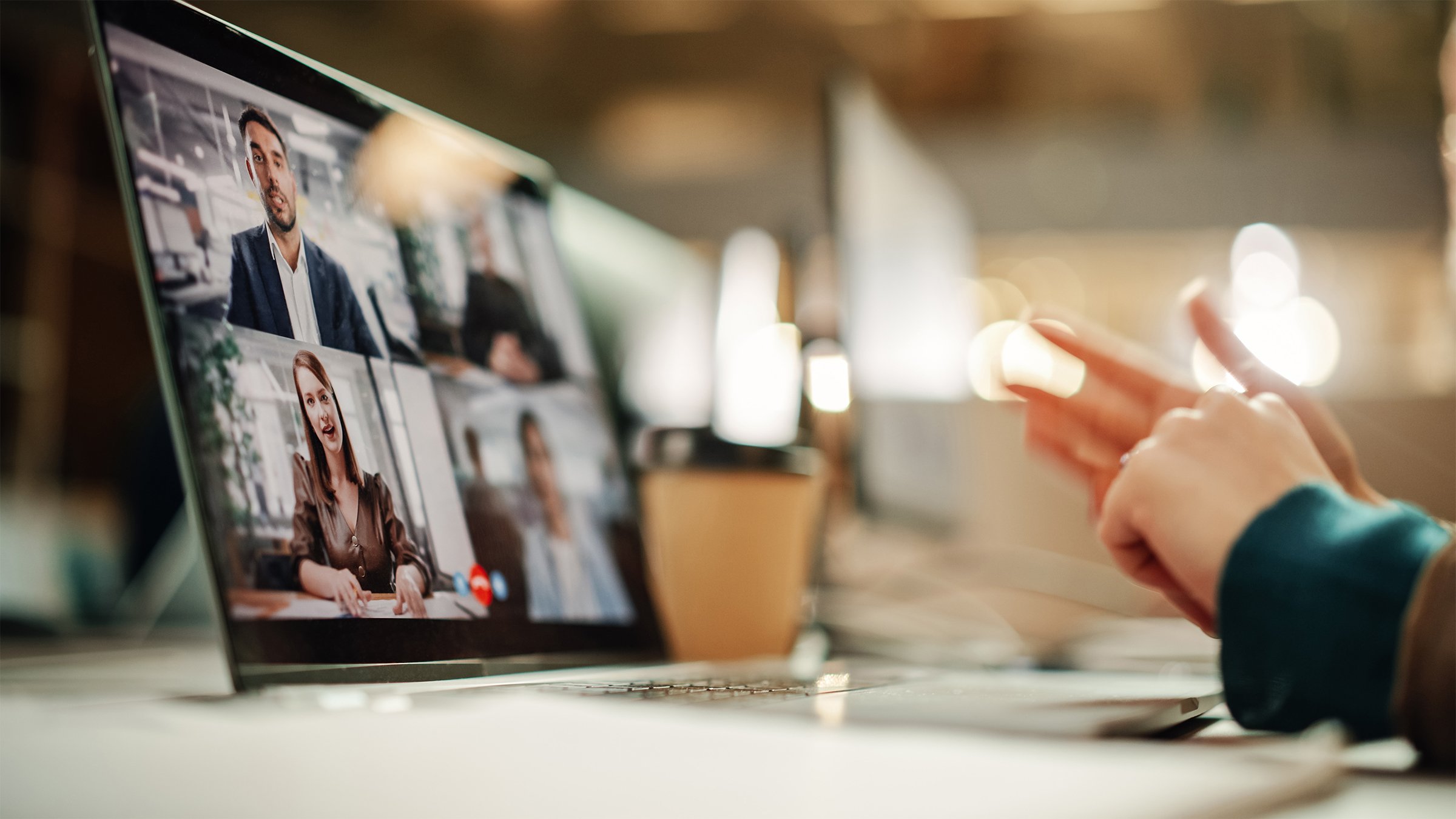 Diverse people on an online laptop video meeting discussing a project.