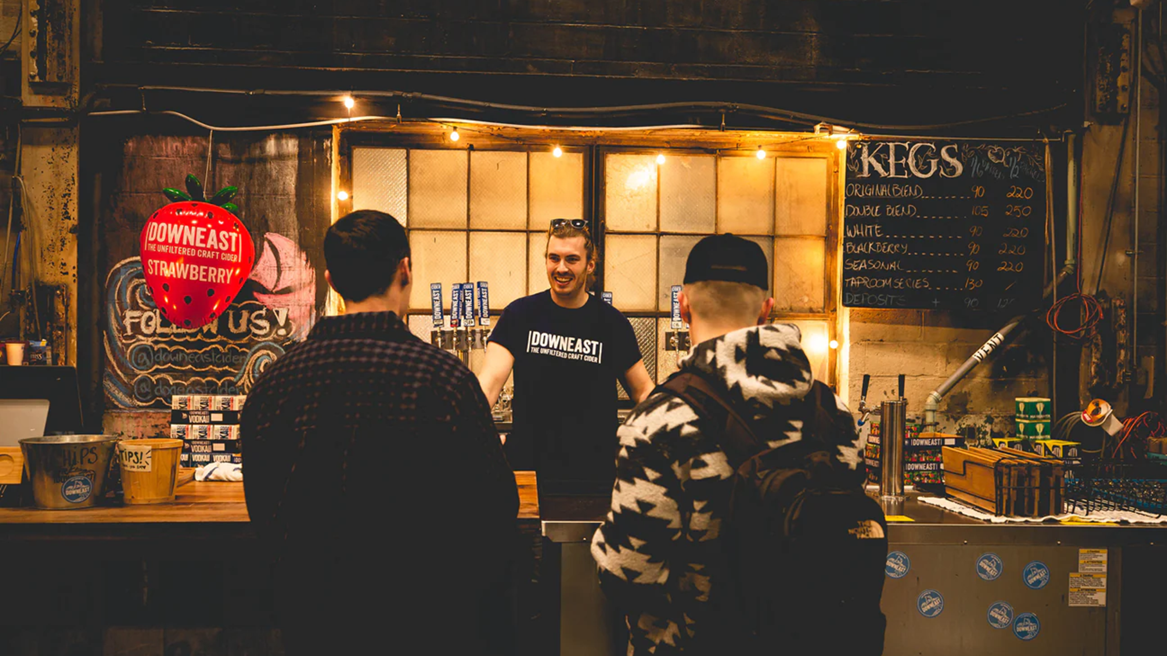 man working front counter at downeast cider house in boston