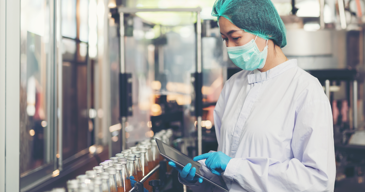 Employee working on a tablet in a beverage production factory