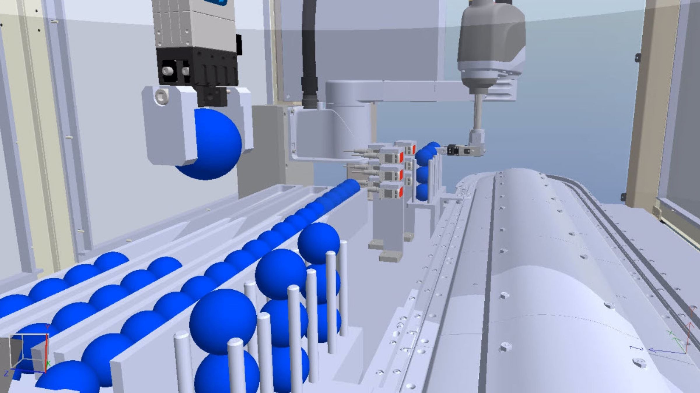 An Emulate3D model showing one robot picking up a blue ball and one placing a blue ball onto an iTRAK 5730 intelligent track system.