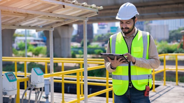 engineer at work site looking at tablet