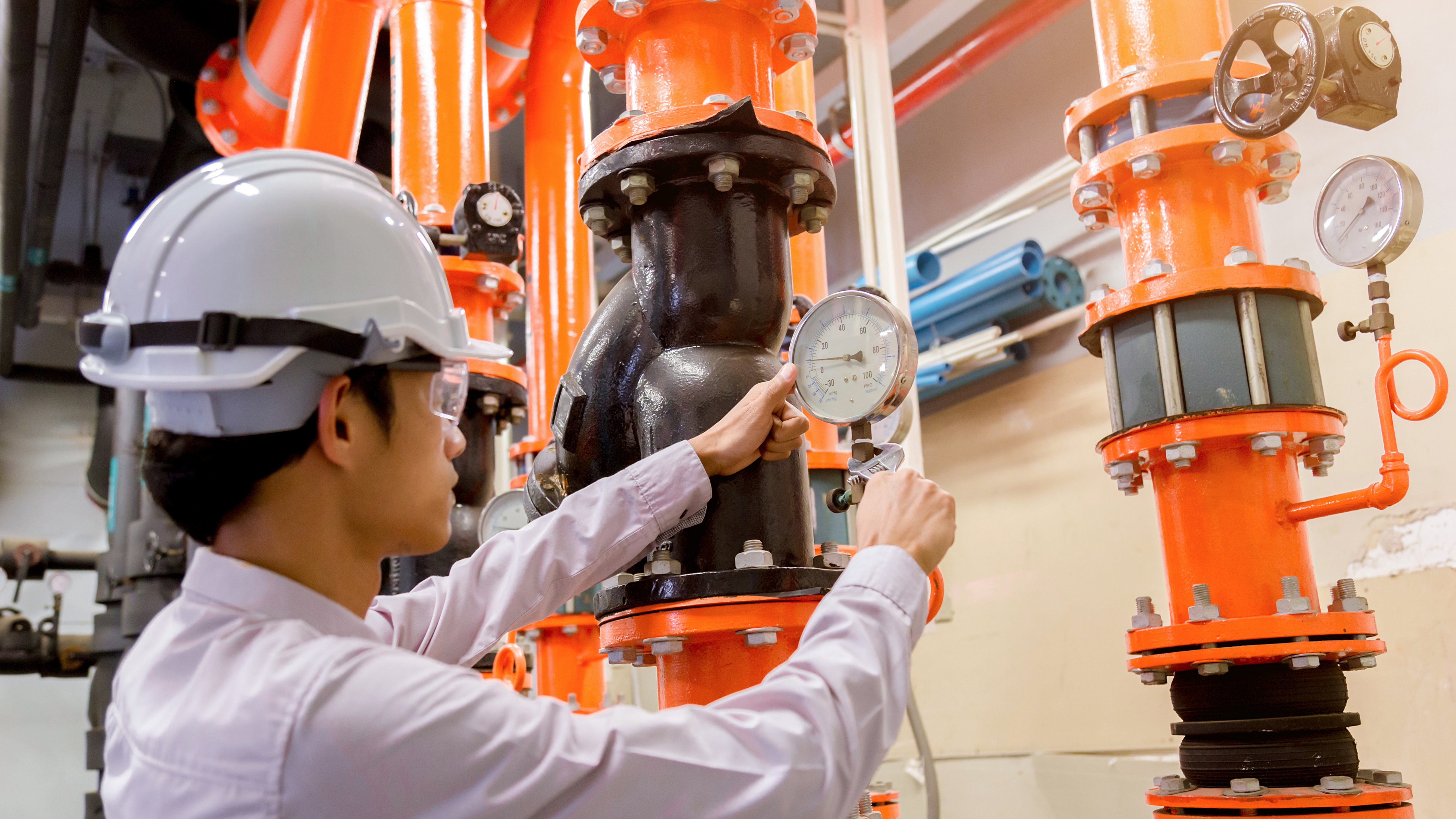 Engineer checking Condenser Water pump and pressure gauge