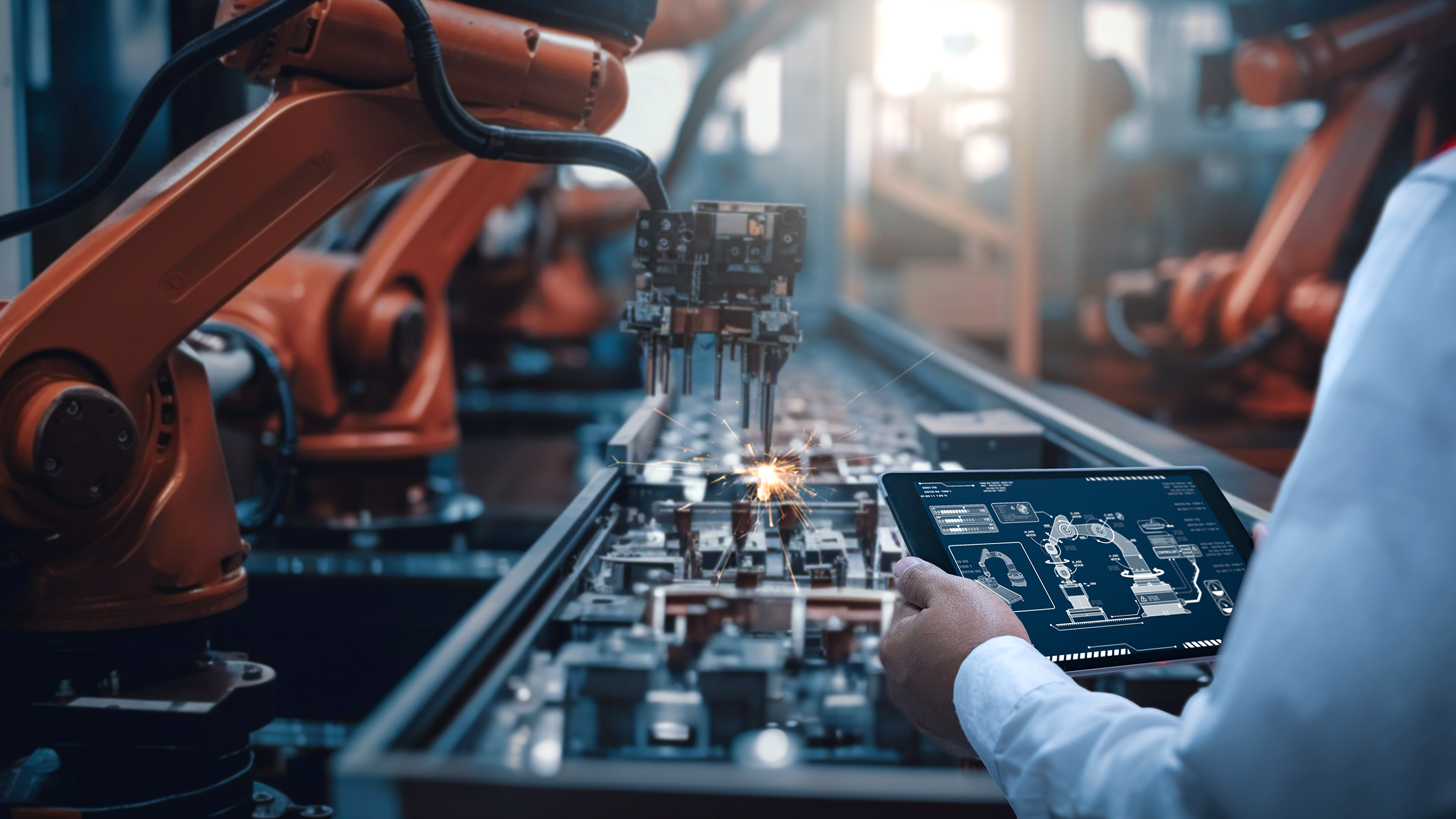 Engineer controlling robotic arm with iPad