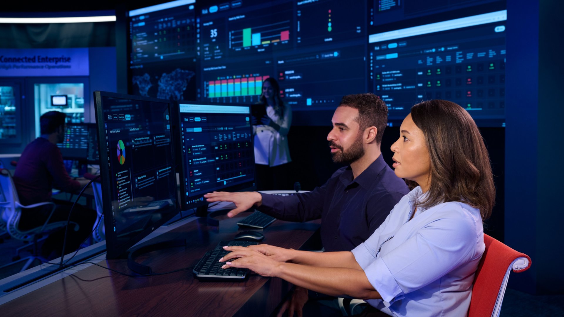 Engineer explaining data on screen monitor to coworker