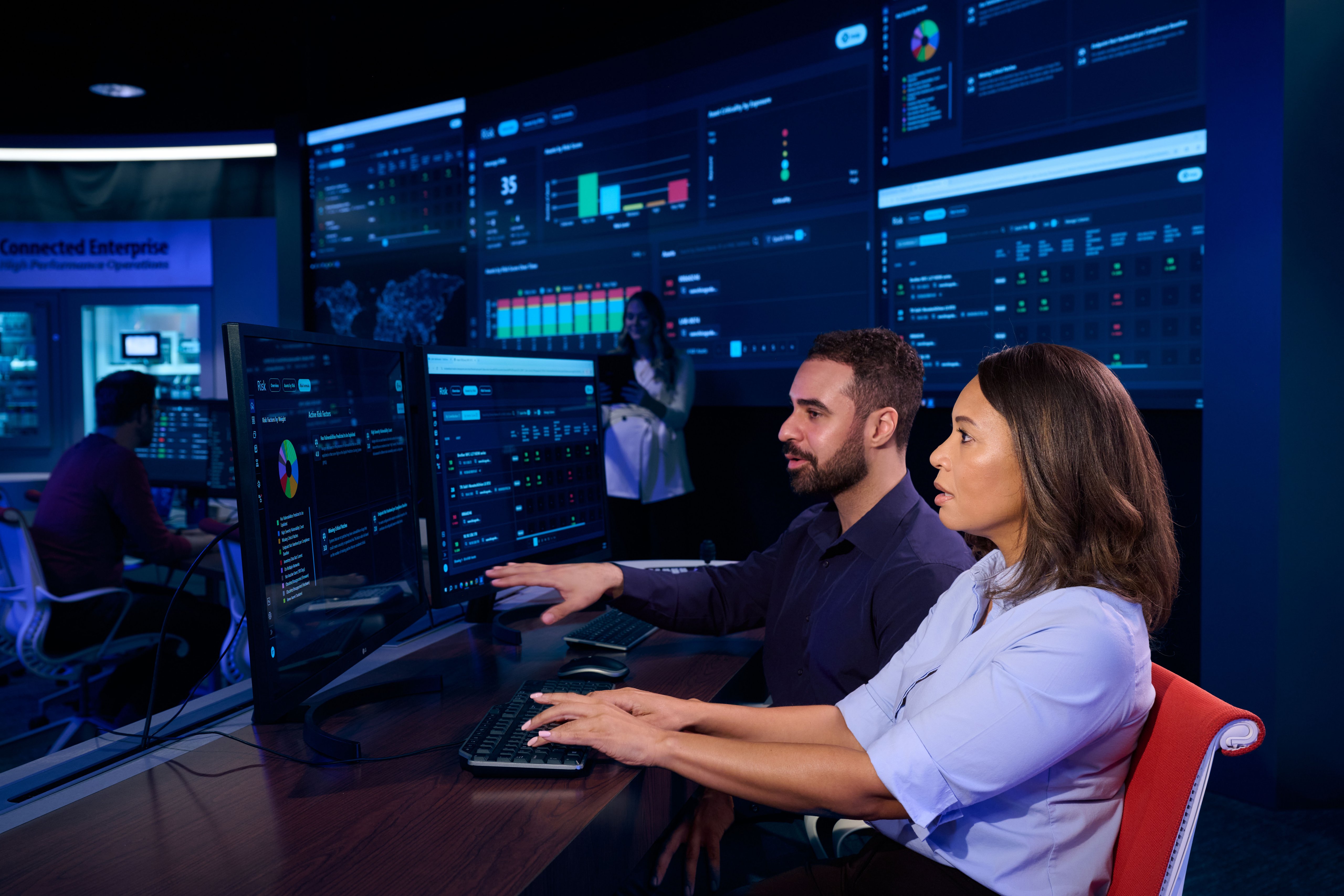 Engineer explaining data on screen monitor to coworker