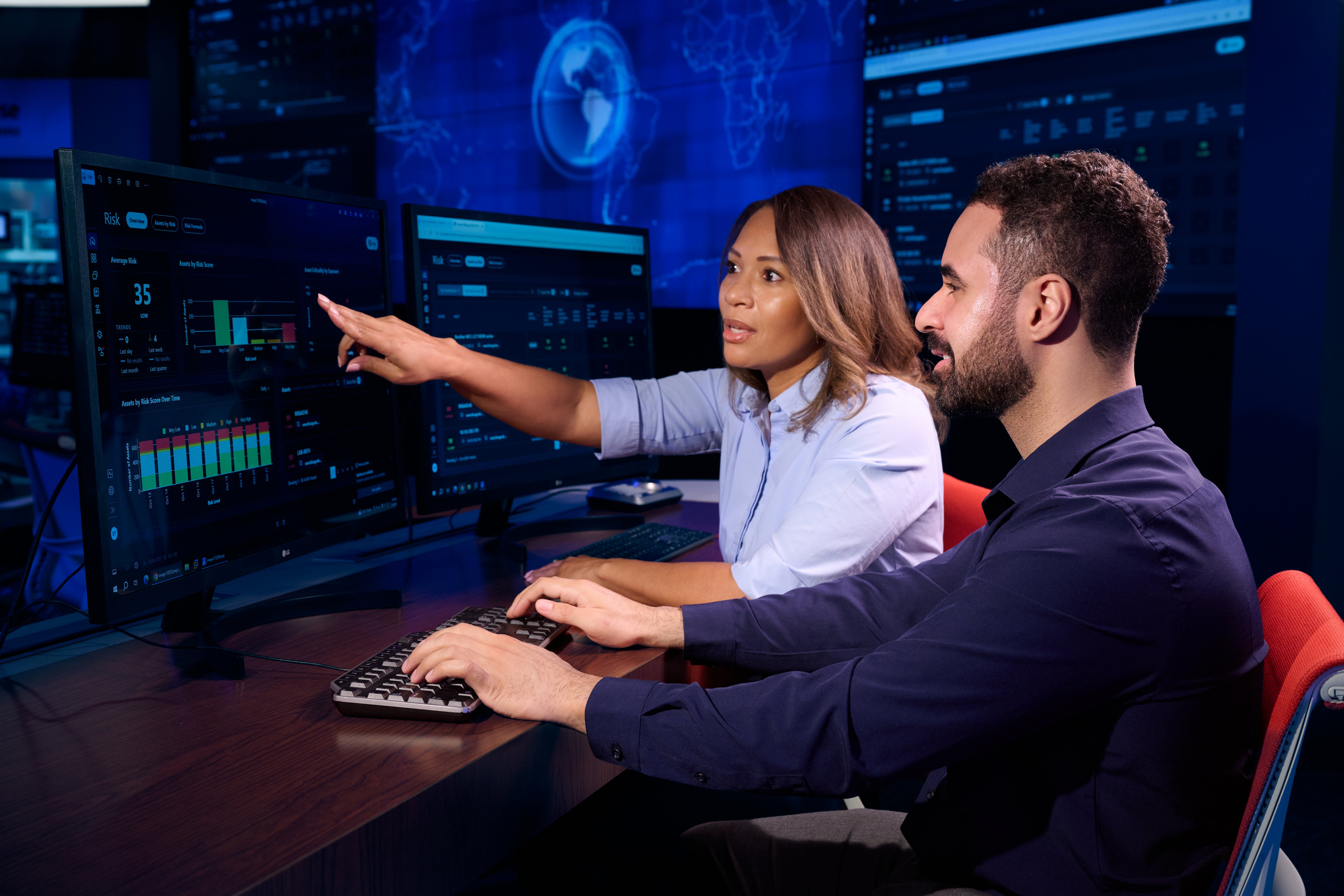 Engineer pointing out data on screen to coworker