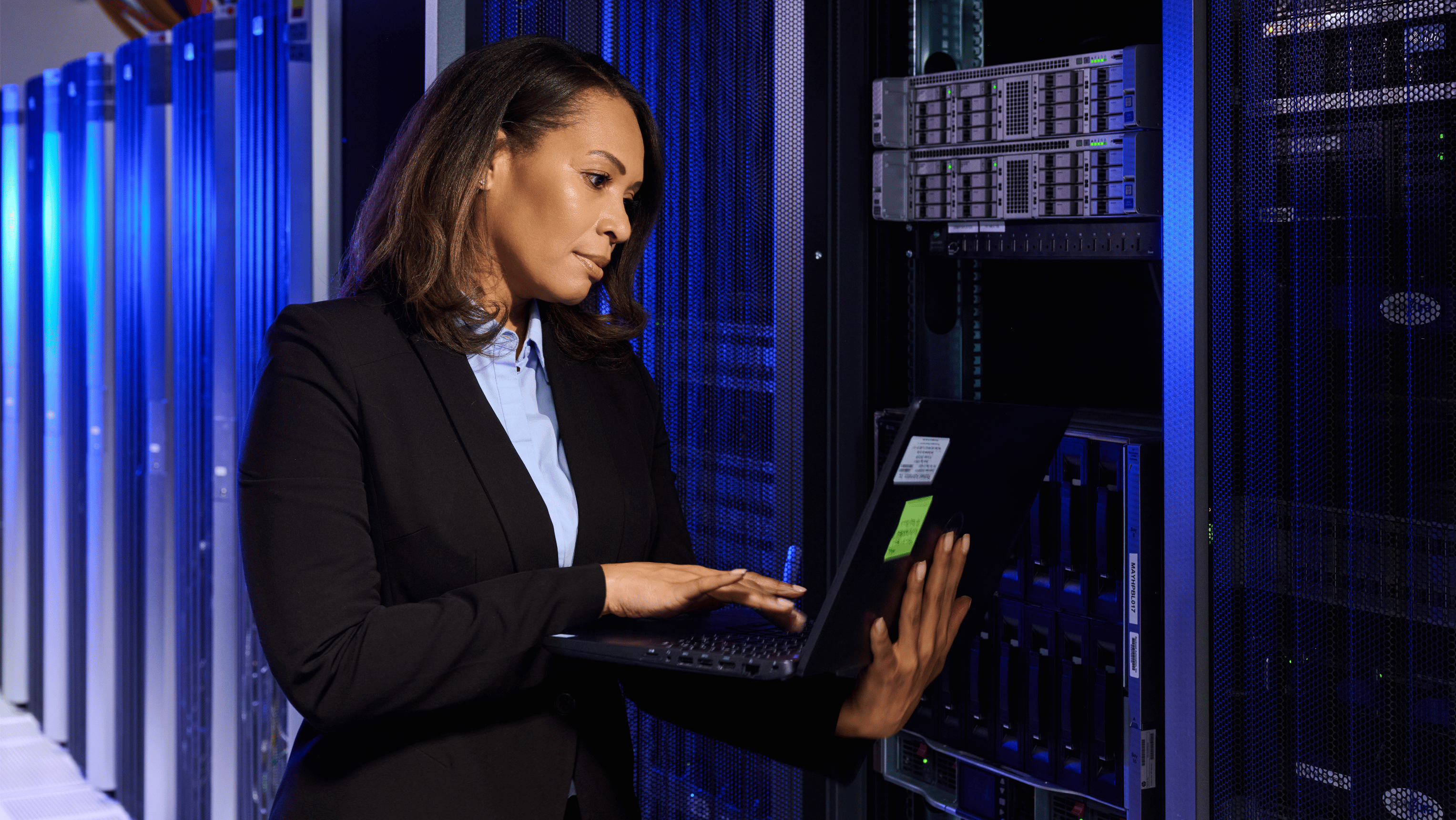 Engineer with tablet in a server room