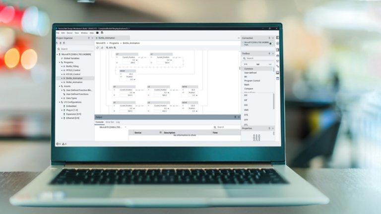 Image of FactoryTalk Design Workbench software screen on a laptop with an open space office background