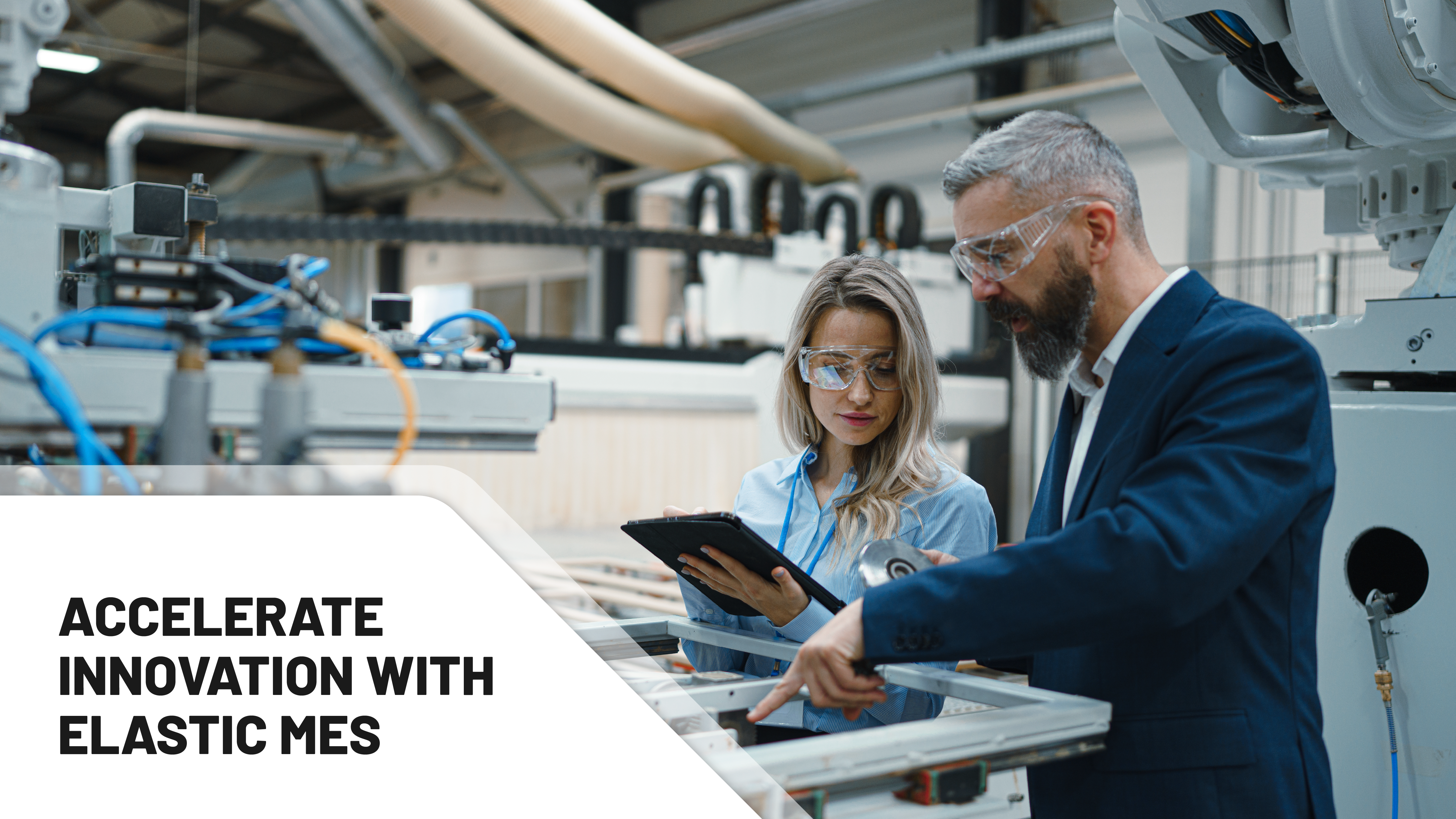 Female engineer and male project manager standing in modern industrial factory