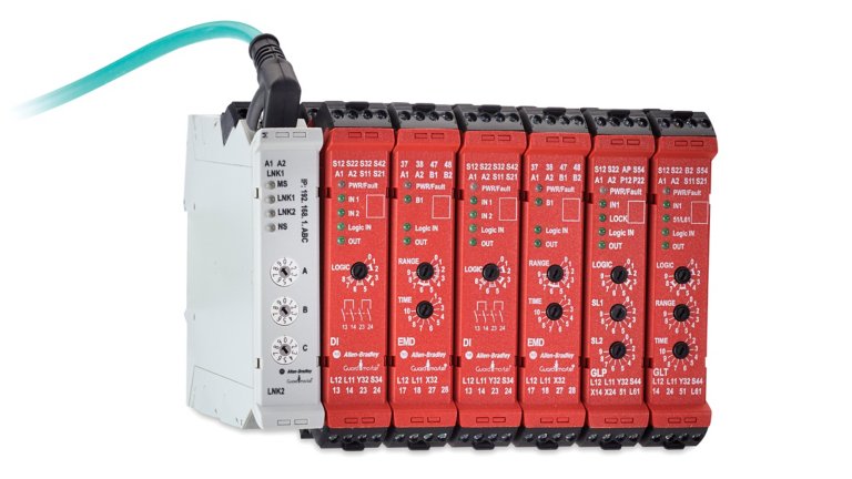 Six red safety relay units and one white safety relay unit with connector, angled left.