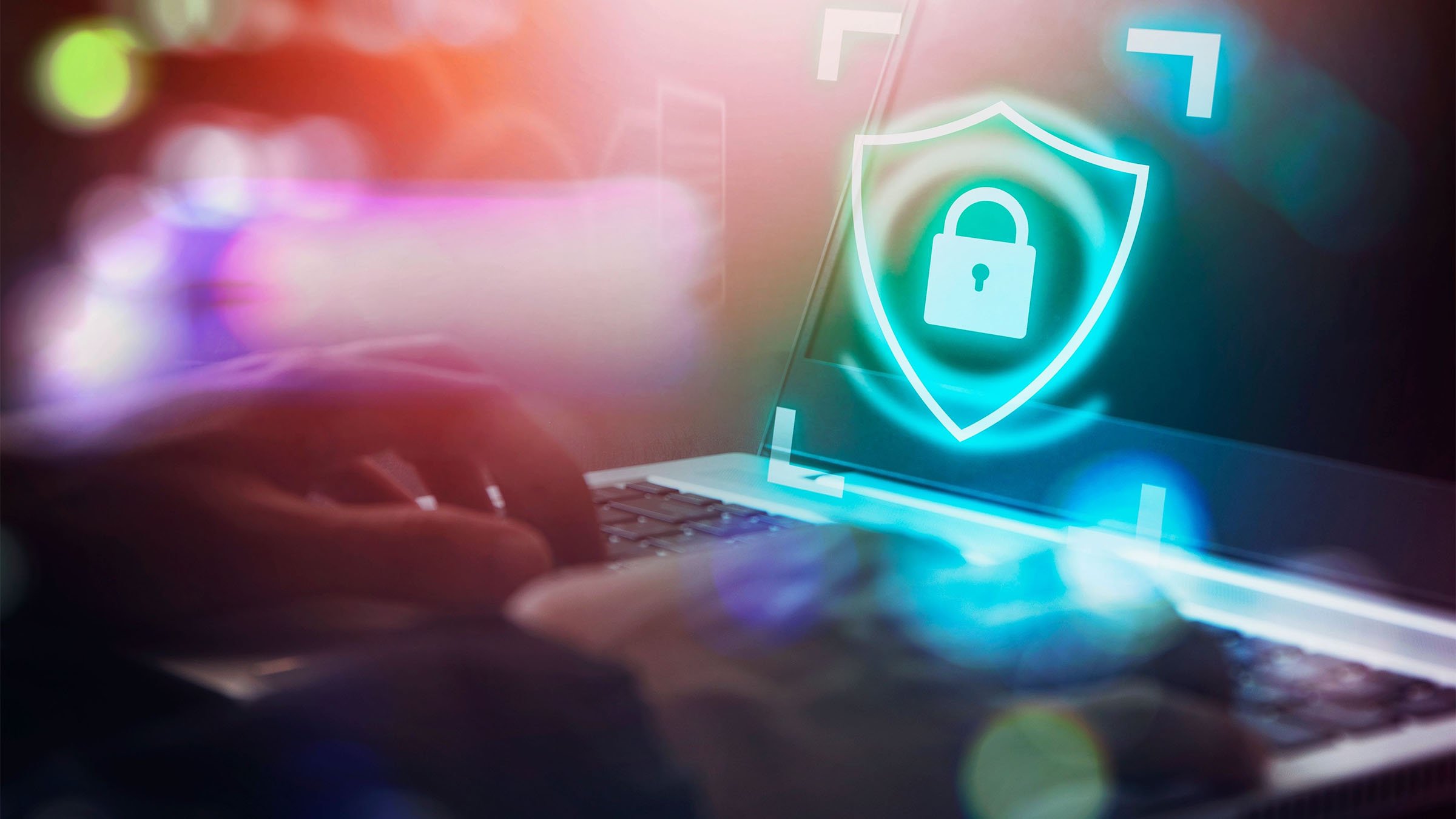 Hands on laptop with a security lock icon displayed in foreground