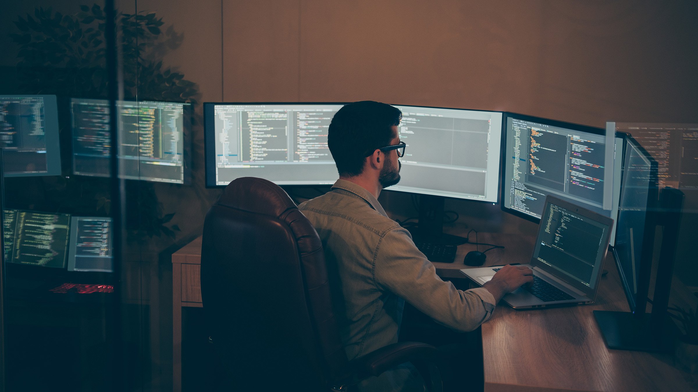 Photo of it-specialist working on global project using laptop testing alpha, version of newly developed software checking bug existence debugging script code