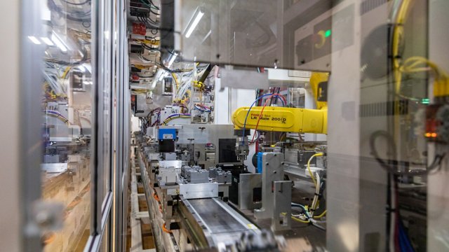 FANUC robots in operation picking and placing contactor components from an iTRAK Intelligent Track System.