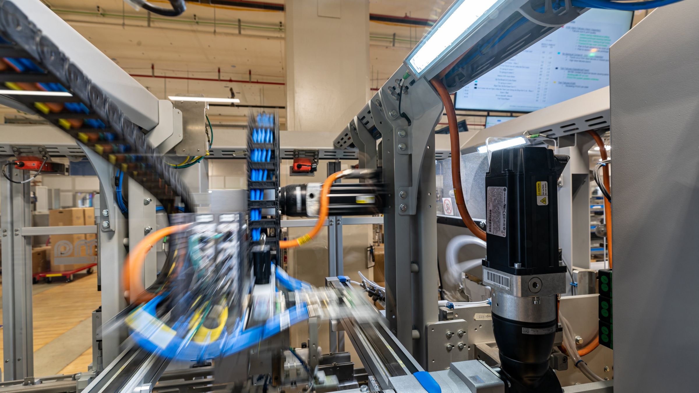 A motion blurred photo of a machine with kinetix servo motors and distributed io blocks.