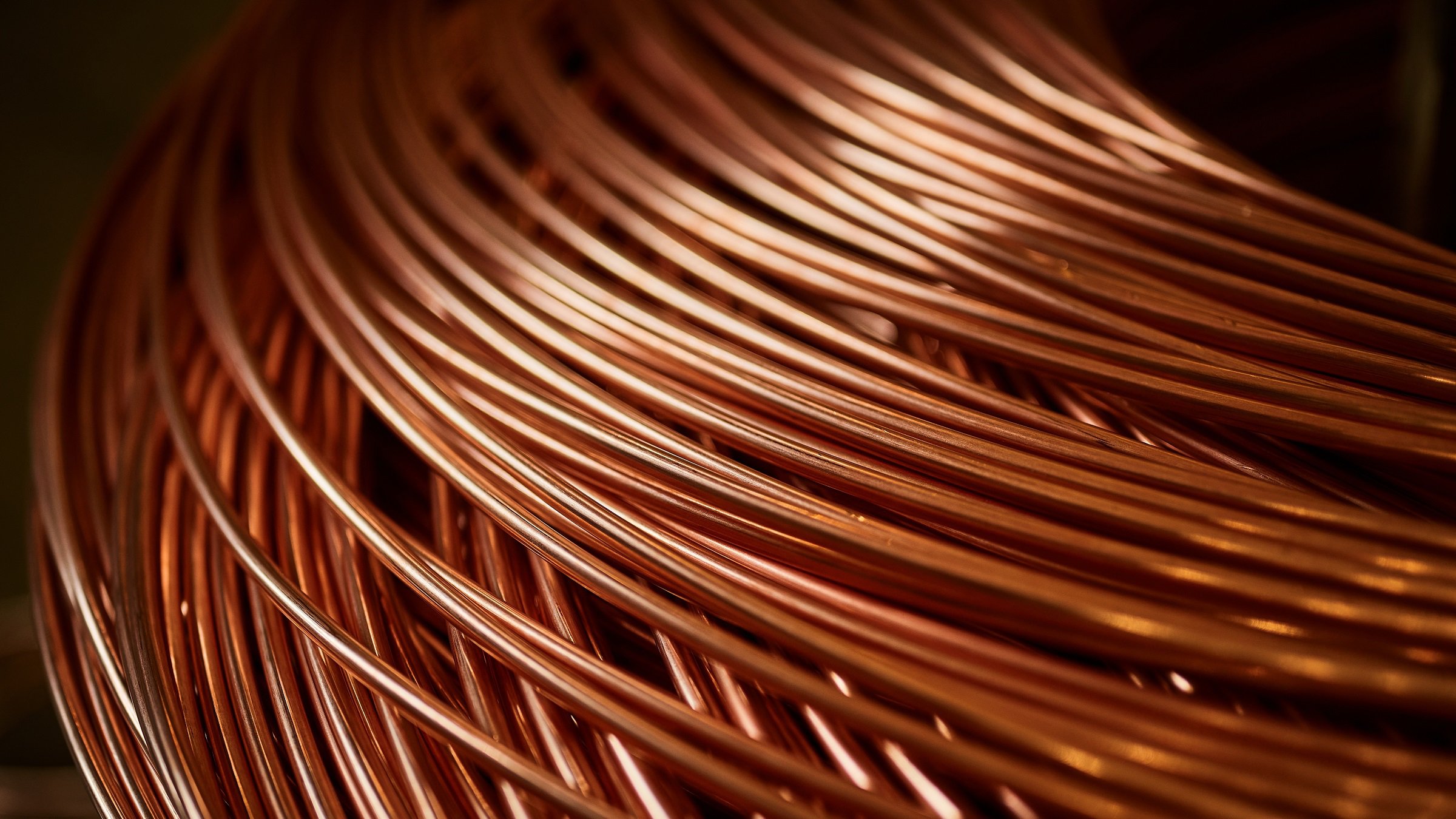 Large bobbin of orange copper wire in light warehouse