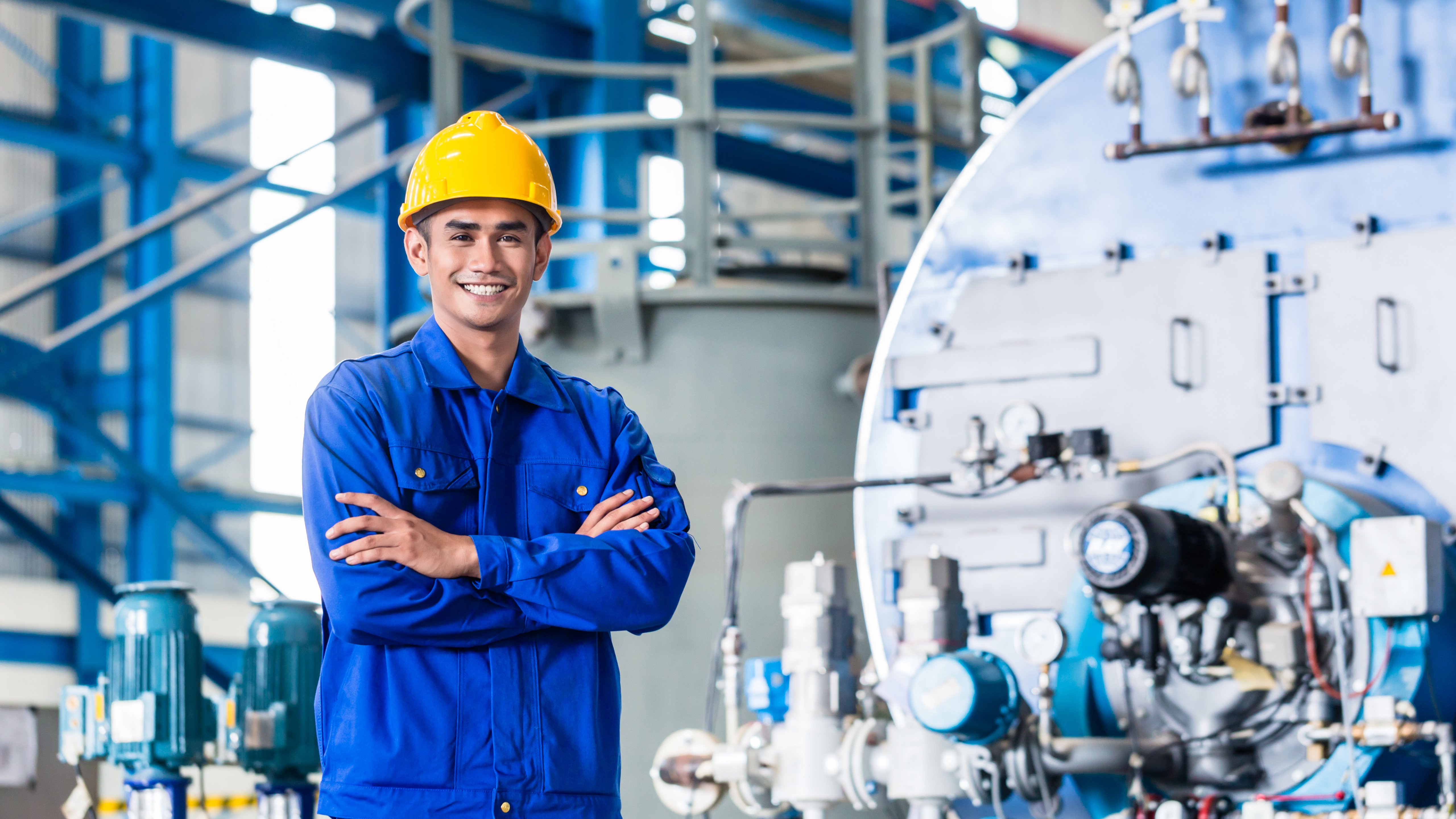 Male Asian worker standing in production factory