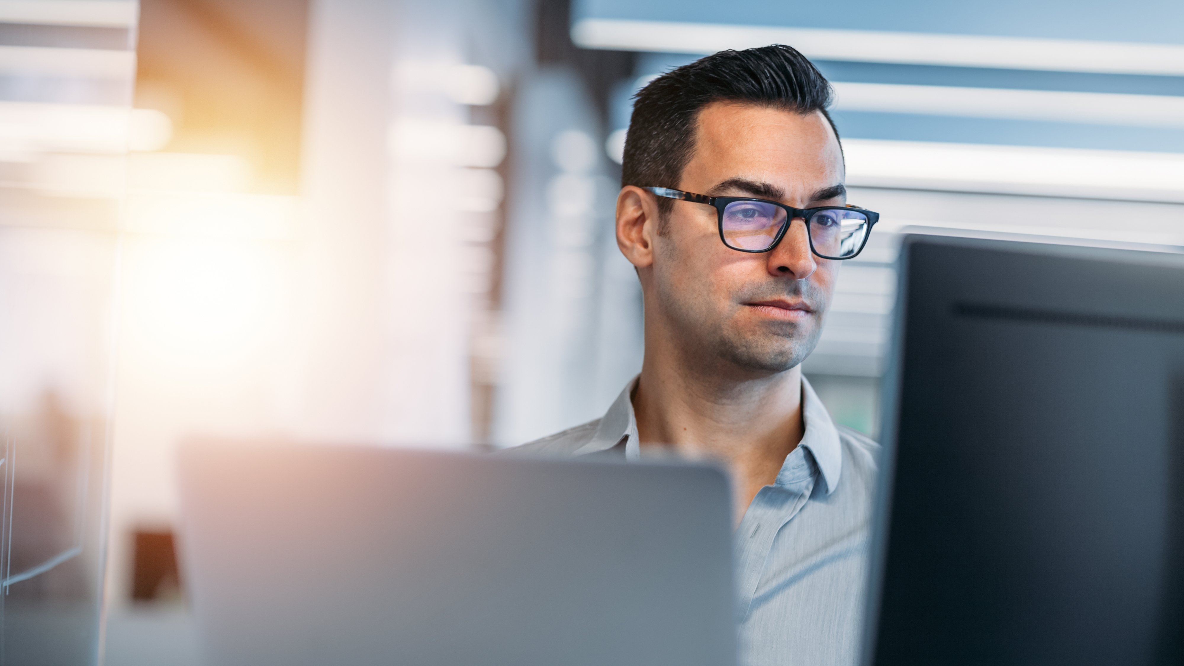 Mature Caucasian man working on laptop in technology office