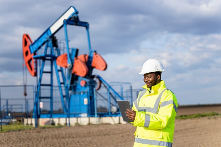 Oil and gas industry. Worker controlling crude oil production.