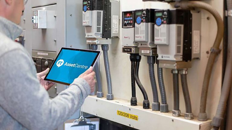 Man holding tablet with FT AssetCentre software monitoring PowerFlex equipment