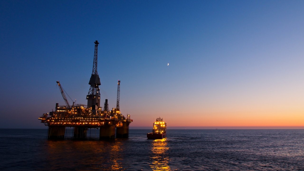 Offshore oil and gas rafinery in sunset