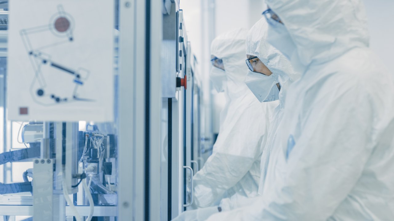 On a Factory Team of Scientists in Sterile Protective Clothing Work