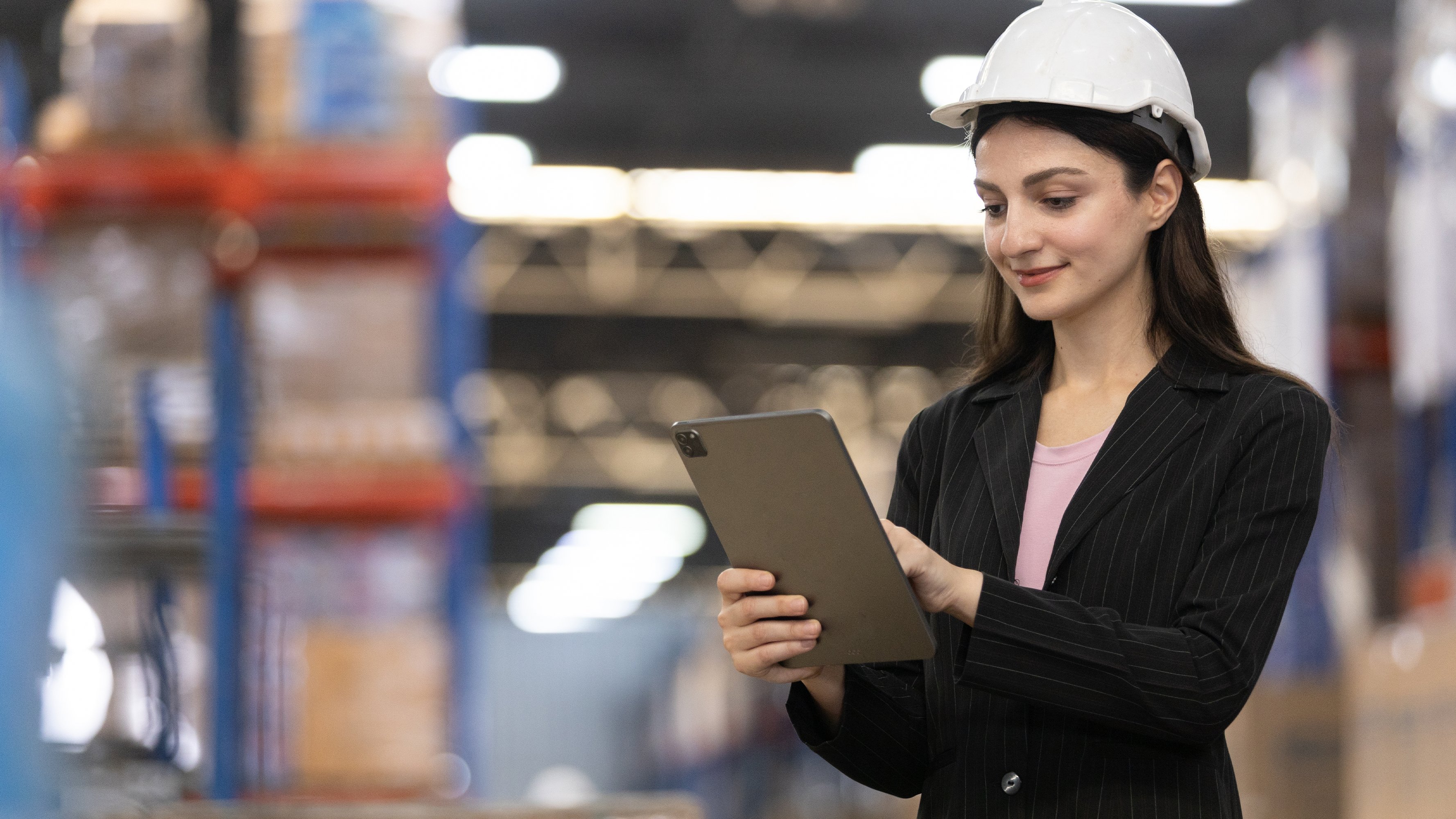 Packaging industry female executive manager using tablet with hard hat