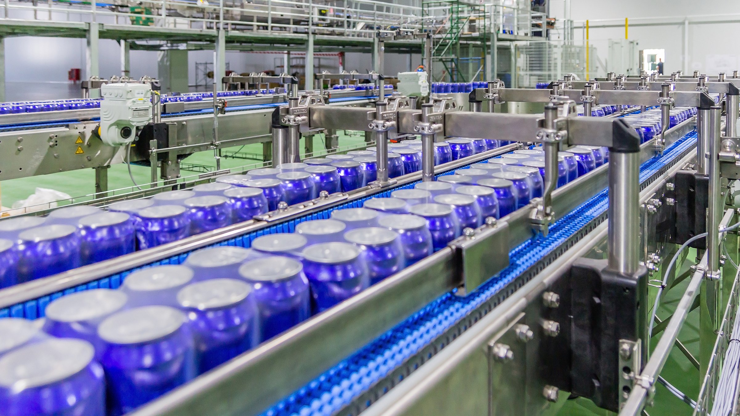 Packed cans on the conveyor belt in berverage factory