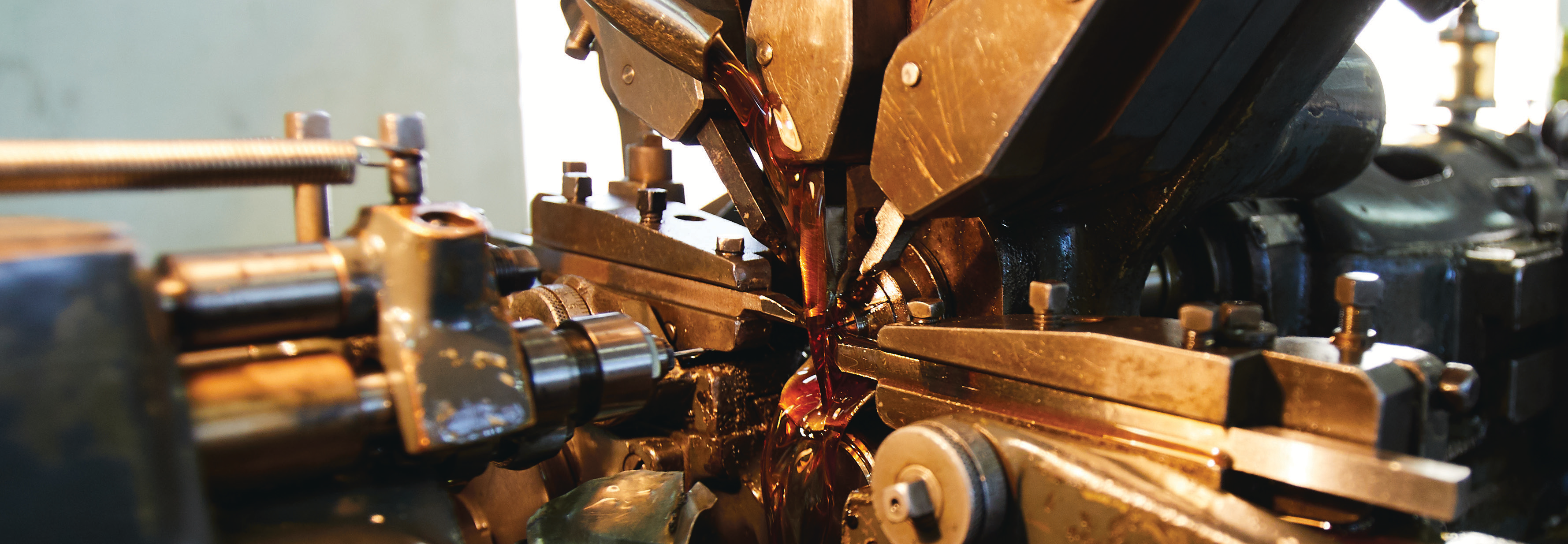 close-up photo of a commutator manufacturing machine with copper and metal parts