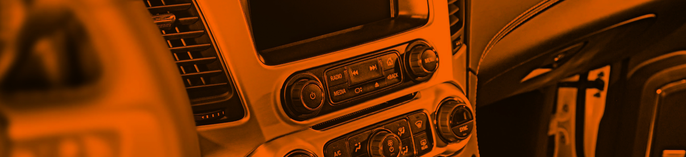 car dashboard close-up photo with orange overlay