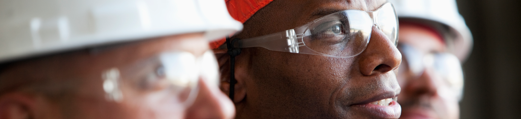 blurred close-up photo of two workers wearing safety helmets