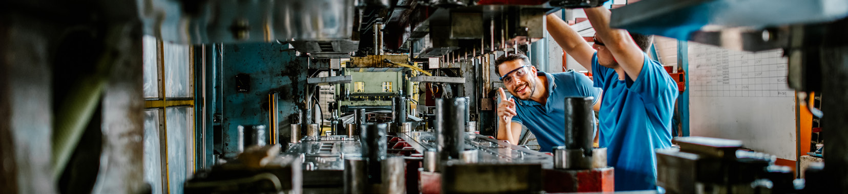 Workers operating production line in a brightly lit manufacturing facility