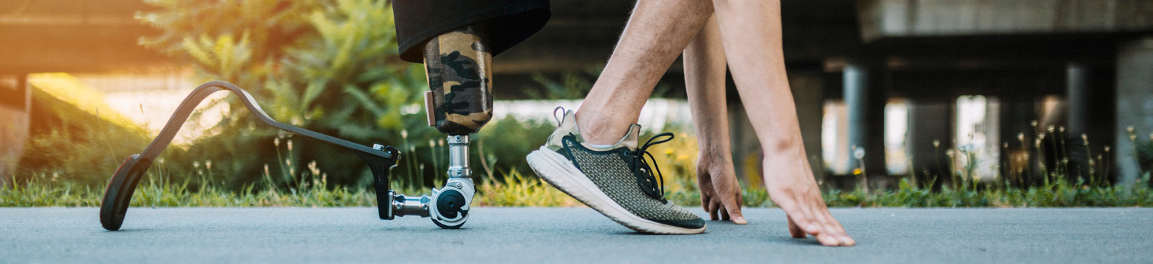 prosthetic foot and athlete preparing to run, outdoor scene