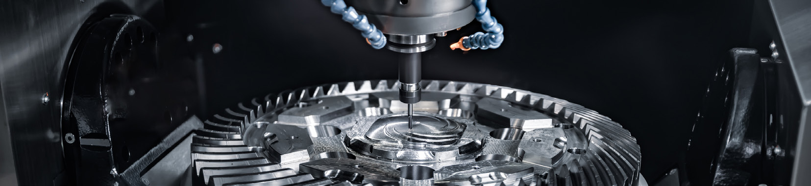 CNC machining close-up photo of a metal gear being machined by a drill in a manufacturing facility