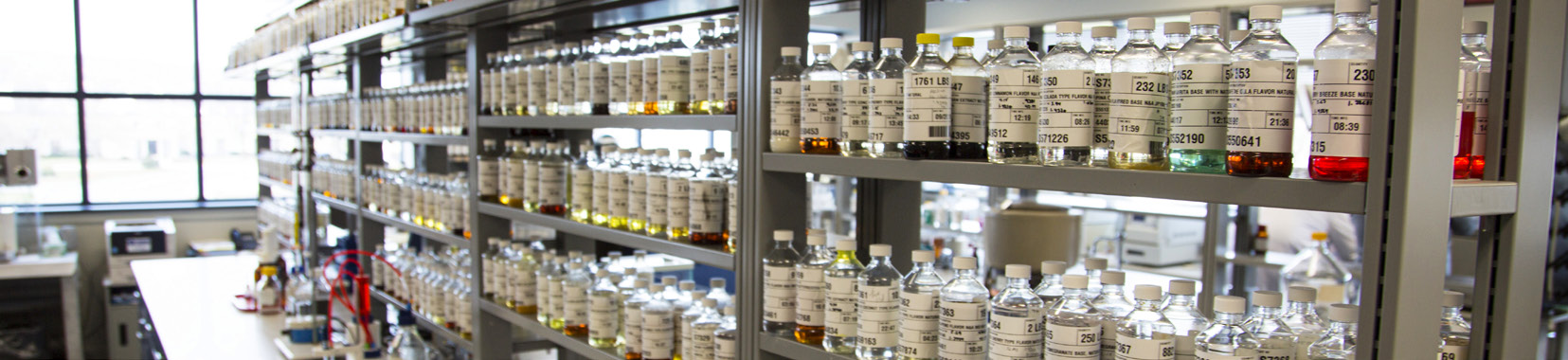 manufacturing facility interior with shelves of bottled extracts and ingredients